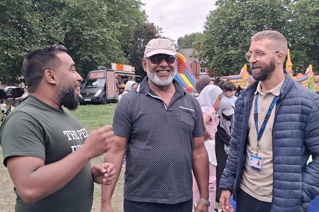 Practitioner talking to visitor at event