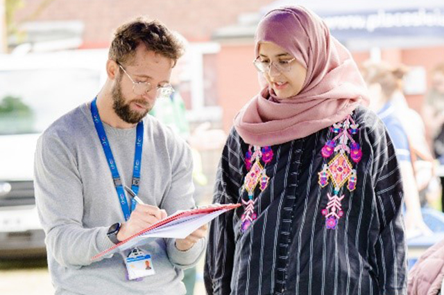 Practitioner talking to visitor at event